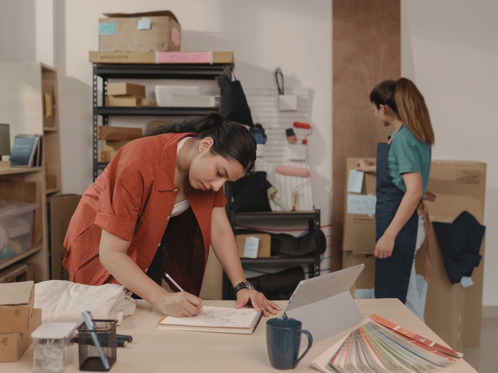 Two people working in a small workshop space