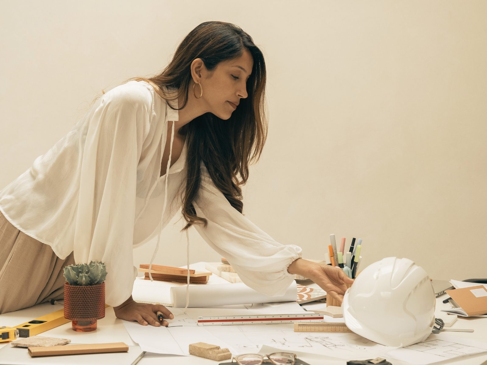 Presenter reviewing plans laid out on a table
