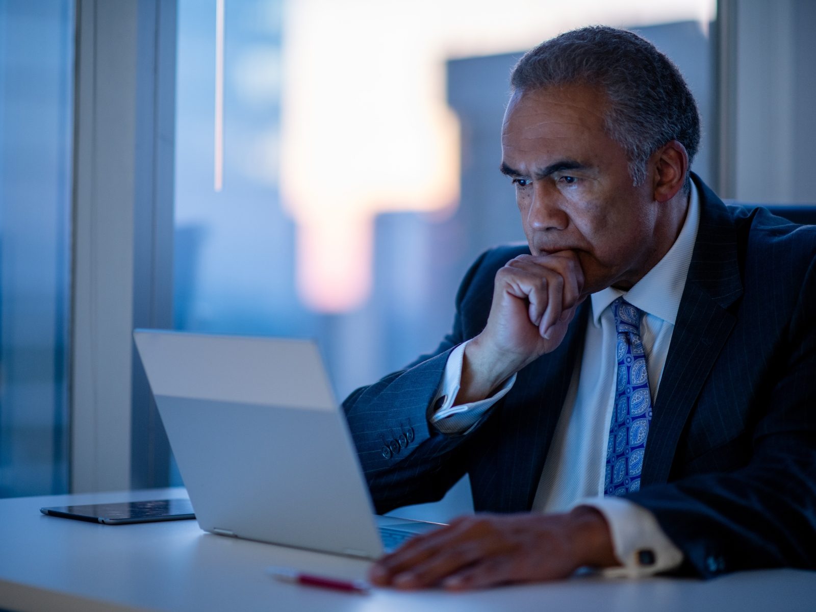 Executive reviewing work at a laptop